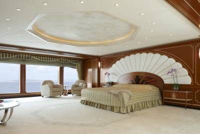 Luxurious yacht bedroom offers stunning ocean views and opulent decor for ultimate relaxation.