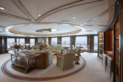 Luxurious yacht interiors offer elegant seating areas with stunning ocean views through panoramic windows.