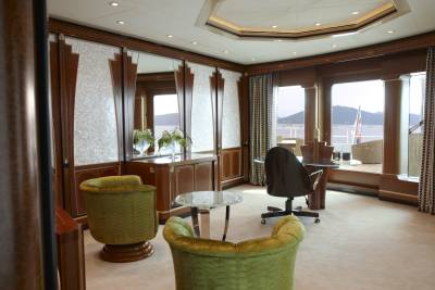 Luxurious yacht interiors offer a serene workspace with stunning ocean views and elegant furnishings.