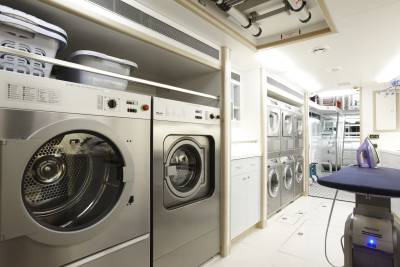 This well-equipped laundry room on a yacht offers multiple Miele washers and dryers for effortless garment care.
