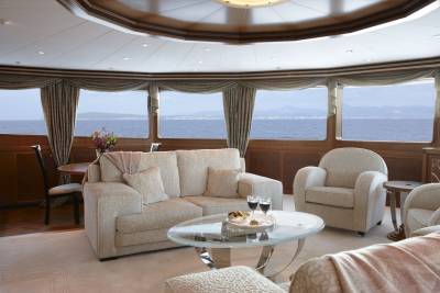 Luxurious yacht interiors offer stunning ocean views through panoramic windows, creating a serene and elegant retreat at sea.