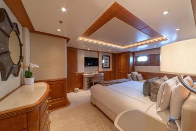 Luxurious wooden paneling and a plush bed create a serene retreat aboard this elegant yacht.