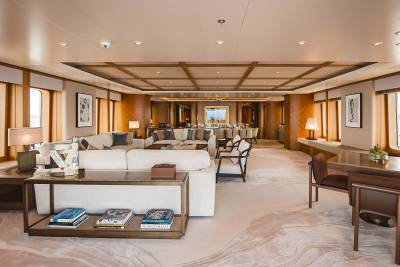 The elegant yacht salon offers a luxurious lounge area and a formal dining space with ocean views.