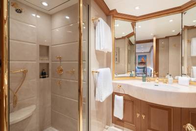 Luxurious gold fixtures and marble accents create an opulent bathroom sanctuary on this yacht.