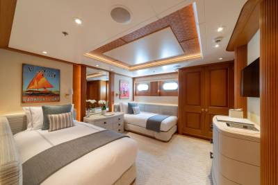 Luxurious twin beds and elegant wood accents create a serene retreat aboard this opulent yacht.