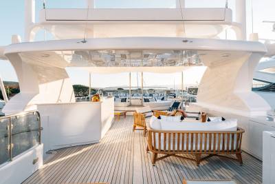 Luxurious outdoor seating and a bar area invite relaxation on the expansive deck of a superyacht.