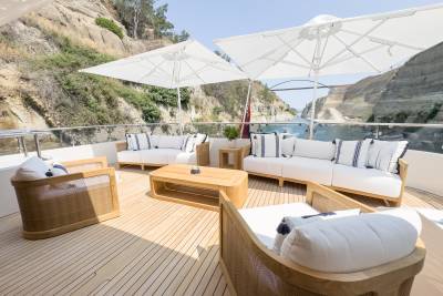 Relax on the luxurious deck of a yacht as it navigates a stunning canal surrounded by dramatic cliffs.