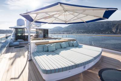 Relax on the expansive sundeck of this luxurious yacht, complete with plush seating and a refreshing hot tub overlooking the azure sea.