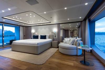 Luxurious yacht bedroom offers stunning ocean views and plush comfort for a serene escape.