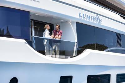 A couple enjoys champagne on the deck of the luxurious yacht Lumière.