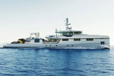 A sleek white yacht cruises through calm blue waters under a bright, clear sky.