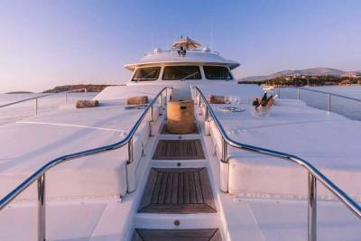 Luxurious yacht deck awaits with chilled champagne and stunning coastal views at sunset.