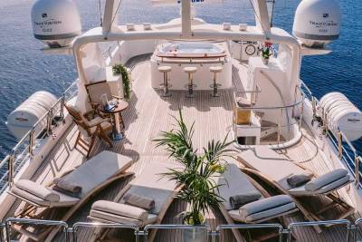 Relax on the spacious deck of this luxurious yacht, complete with a hot tub and comfortable loungers.