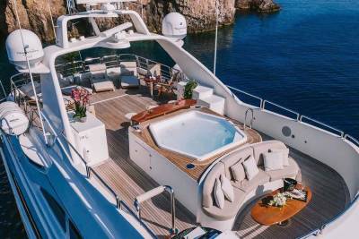 Relax in the onboard jacuzzi and lounge areas of this luxurious yacht while surrounded by stunning coastal scenery.