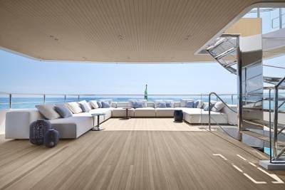 Luxurious outdoor seating on a yacht deck offers a serene escape with stunning ocean views.
