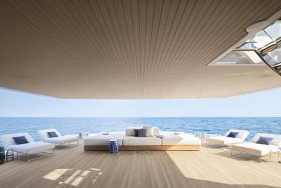 Relax on the spacious deck of a luxury yacht, surrounded by the serene blue ocean and modern comfort.