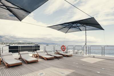Relax on the spacious deck of a luxury yacht, surrounded by the serene beauty of the Mediterranean coast.