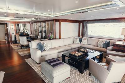 Luxurious yacht interiors feature plush seating and elegant decor, offering a sophisticated space for relaxation.
