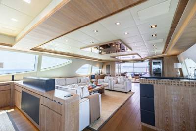 Luxurious yacht interiors offer breathtaking ocean views through expansive windows and elegant seating areas.