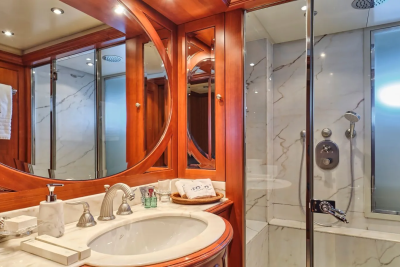 Luxurious wood finishes and marble accents create an opulent bathroom sanctuary on this elegant yacht.