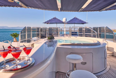 Enjoy refreshing cocktails by the jacuzzi on this luxurious yacht deck with stunning ocean views.