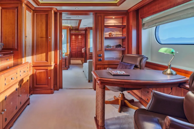 Luxurious wood paneling and plush leather furniture create a refined office space aboard this elegant yacht.