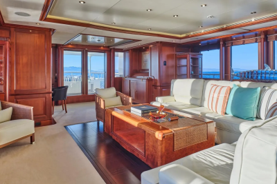 Luxurious yacht interiors offer a serene escape with plush seating and stunning ocean views through large windows.