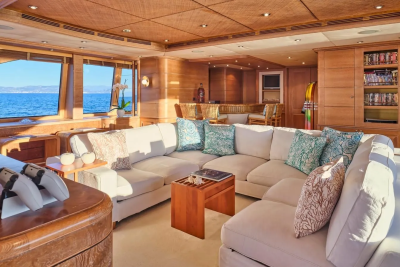 Luxurious yacht interiors blend warm wood tones with ocean views and comfortable seating for ultimate relaxation.
