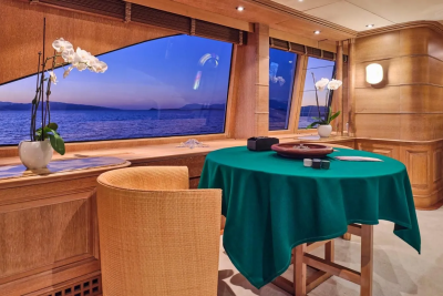 Enjoy a game of chance with a stunning sunset view over the tranquil sea from this luxurious yacht salon.