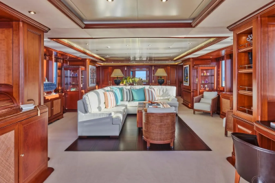 Luxurious wood paneling and plush seating create an elegant and inviting atmosphere in this yacht's spacious salon.
