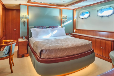 Luxurious wood paneling and soft lighting create a serene retreat aboard this elegant yacht cabin.