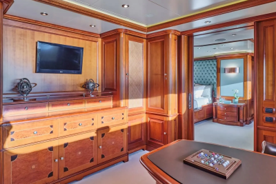 Luxurious wood paneling and elegant furnishings create a sophisticated office and bedroom suite aboard this opulent yacht.