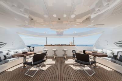 Relax in style on this luxurious yacht's deck, complete with a bar, comfortable seating, and stunning ocean views.
