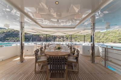 Dine al fresco on the spacious deck of this luxurious yacht, surrounded by stunning coastal scenery.