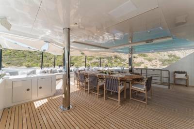 Dine al fresco on the spacious deck of this luxurious yacht, surrounded by stunning coastal views.