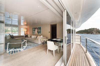 Luxurious yacht interiors open onto the sparkling blue sea, offering breathtaking views and elegant relaxation.