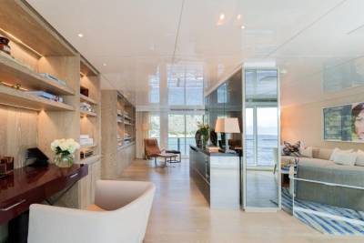 A modern living area with built-in shelving and a stunning ocean view offers a luxurious retreat.
