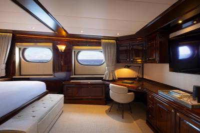 A cozy and well-appointed cabin interior with wooden paneling, large windows offering scenic views, and various furnishings and amenities, creating a comfortable and luxurious atmosphere.