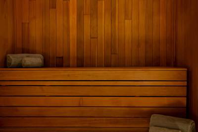 A cozy wooden sauna interior with benches and a warm, inviting atmosphere.
