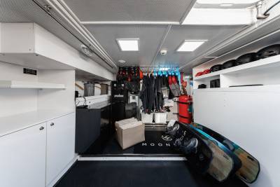 A well-organized and spacious interior of a vehicle, with various storage compartments, shelves, and hanging racks for storing and displaying a variety of items, including clothing, gear, and other personal belongings.