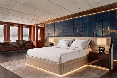 A luxurious bedroom with a plush bed in the foreground and large windows overlooking a serene landscape in the background.