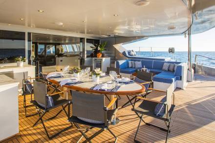 Dine al fresco on the spacious deck of this luxury yacht, surrounded by the sparkling blue ocean.