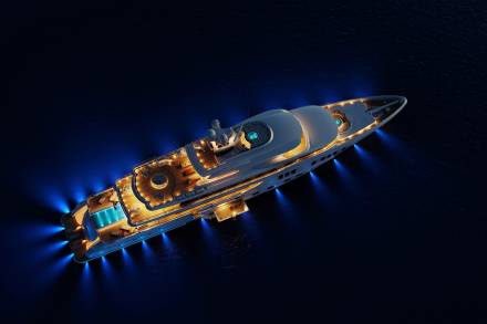 A luxurious yacht illuminates the dark ocean with its warm interior lights and striking blue underwater beams.