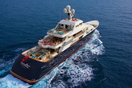 The luxurious yacht "Ocean Dream" cruises through the deep blue sea, leaving a foamy wake behind.