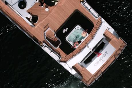 Two women relax in a hot tub on the deck of the yacht Ghost in Sydney.