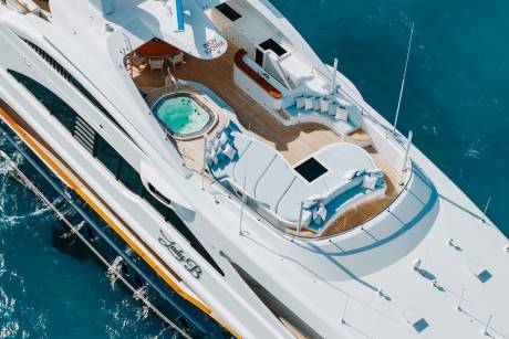 The luxurious yacht "Lady B" offers a serene oasis with its inviting hot tub and plush seating areas on deck.