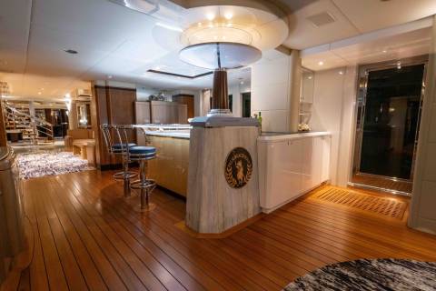 A spacious and well-appointed kitchen with a central island, wooden floors, and a variety of lighting fixtures, creating a warm and inviting atmosphere.