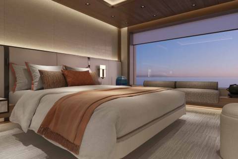 Luxurious bedroom with a stunning ocean view and a cozy throw blanket draped over the bed.