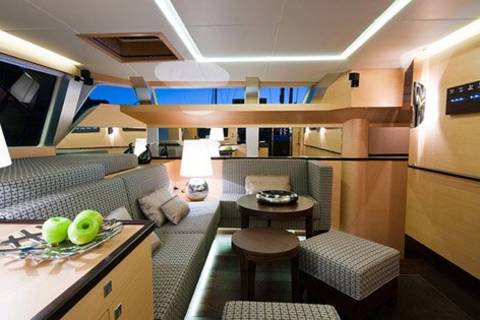 Luxurious yacht interiors offer a cozy and elegant lounge area with plush seating and ambient lighting.