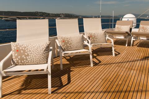 Relax on the sun-drenched deck of a luxury yacht, enjoying the serene coastal views.